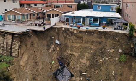 Oceanfront homes crumble in California as torrential rains lead to landslides