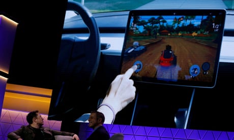 US investigates claim Tesla drivers can play video games while driving